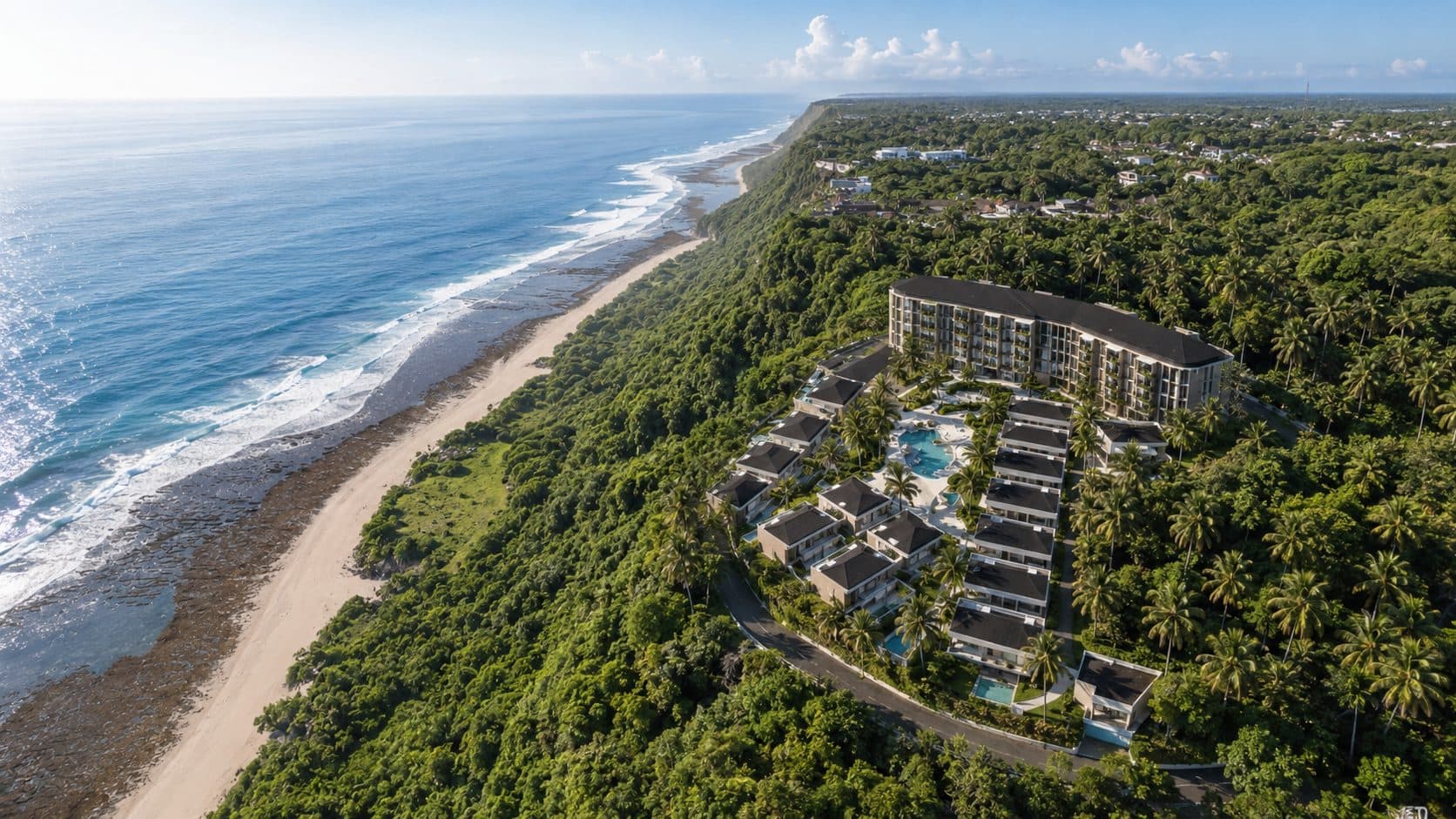 Aerial view of the Uluwatu coastline with the development shown among the clifftop forest